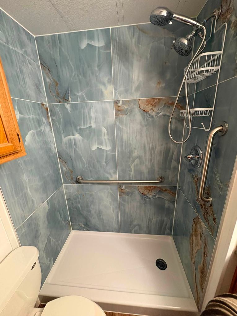 Blue marble porcelain tile shower with dual shower head and grab bars installed by NoBull Man